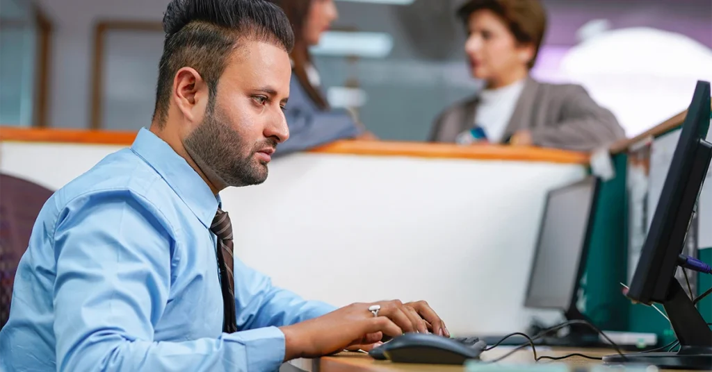 Focused professional working in office, representing how upcoming tax changes may affect individuals and businesses.