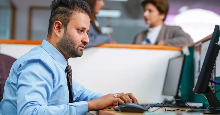 Focused professional working in office, representing how upcoming tax changes may affect individuals and businesses.