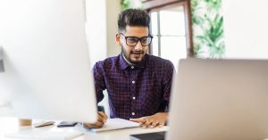 Professional reviewing candidate details on dual monitors — highlighting what employers should look for in job references during the hiring process