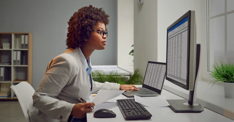 Focused professional studying spreadsheets — representing how to stay focused while studying for the CPA exam