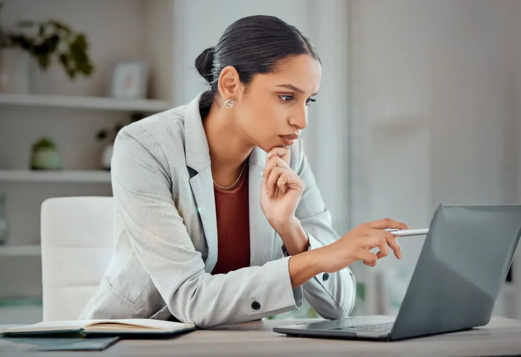 CIA candidate sitting at desk on a laptop preparing for the exam.