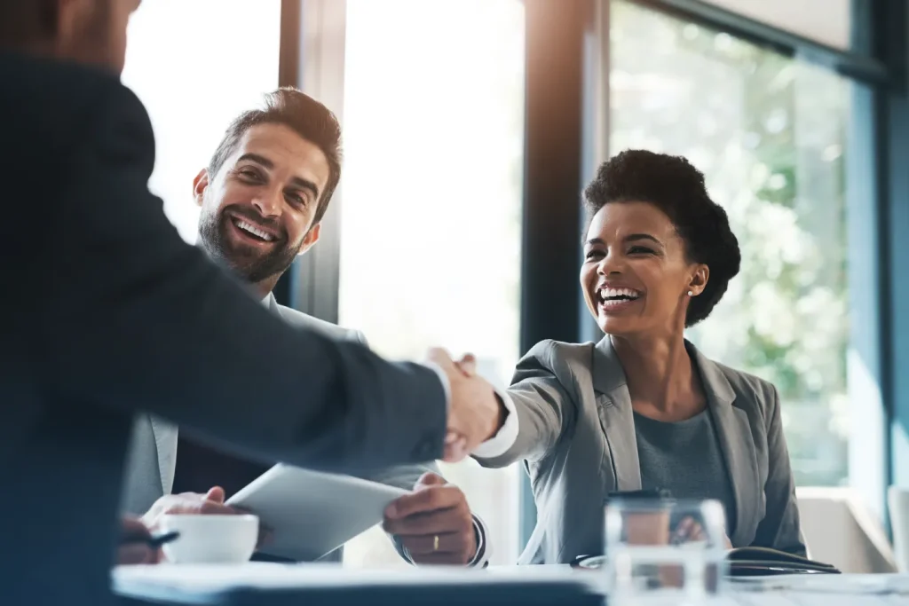 CMAs around a meeting table shaking hands