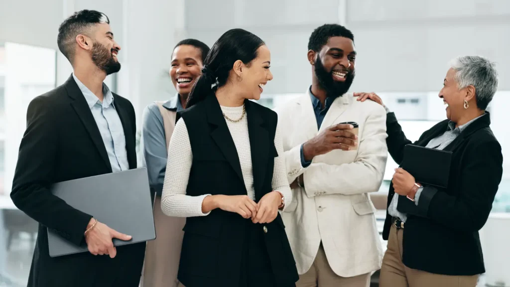 Working professionals standing together in an office setting.