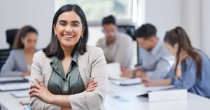 CMA candidate at work, posing in front of a conference room table with colleagues