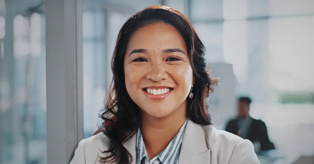 CMA candidate smiling in front of a conference room.