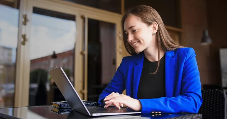 CMA candidate studying via laptop and notebook