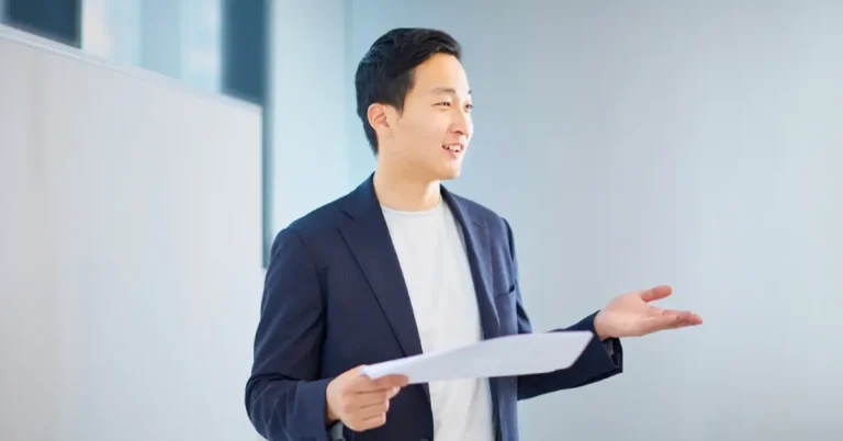 Young business professional presenting in front of white board