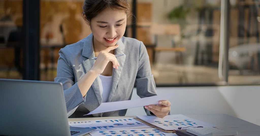 Focused CPA candidate reviewing printed charts and study notes, an effective way to study for the CPA Exam