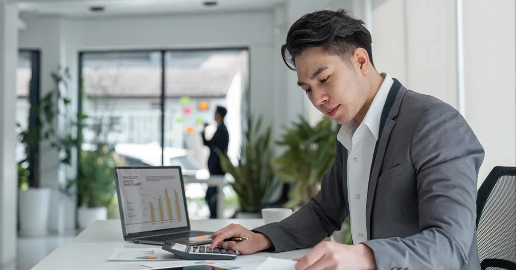 CPA candidate reviewing business reports and data analytics using top-rated BAR CPA review materials on a laptop