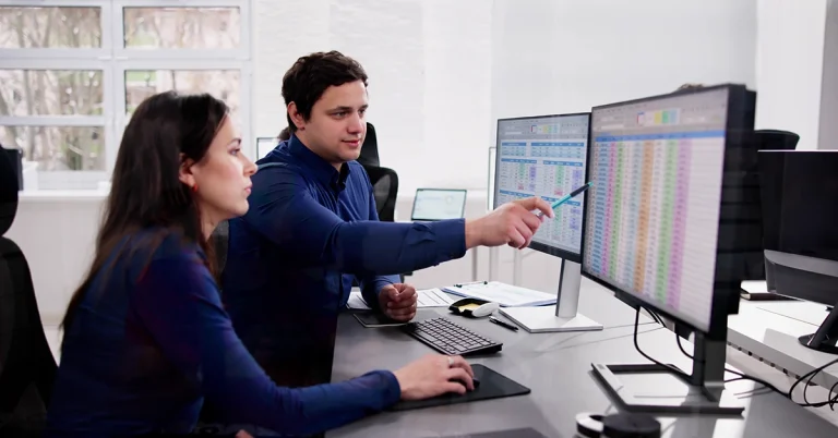 Non-accounting majors reviewing CPA course materials on computer screens in an office
