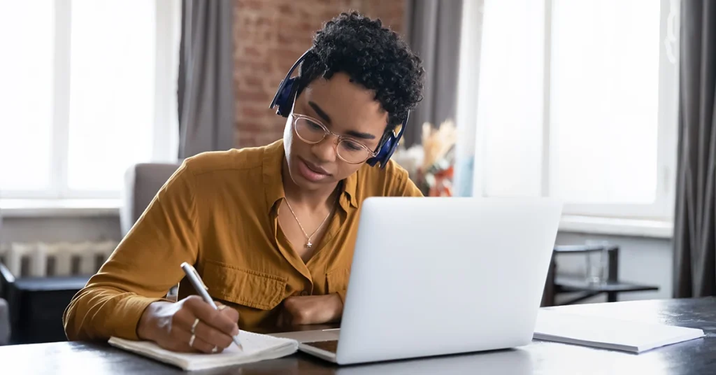 CPA candidate studying online with headphones for the best TCP CPA review course.